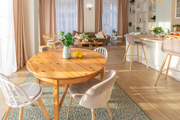 modern expensive luxurious open-plan apartment. Rich Scandinavian-style interior with wooden beams on the ceiling in pastel colors