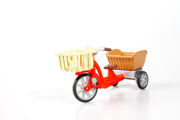 Fototapeta na wymiar red tricycle with basket on white background