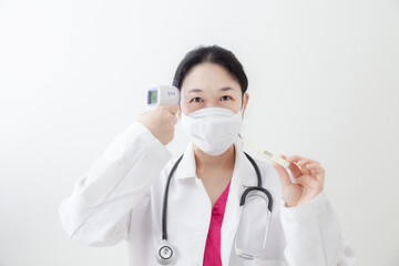 Asian female doctor is recommending medication, wearing a mask and checking body temperature while examine the patient via video call. Health care and prevention COVID-19 strategy Coronavirus concept