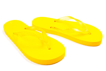 yellow rubber beach flip flops on a white background, isolate