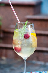 sangria wine alcohol drink cocktail with fruits and drinking straw in glass, bar