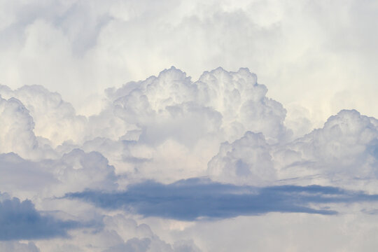 Large white structure Cumulonimbus calvus clouds close-up. Thunderclouds