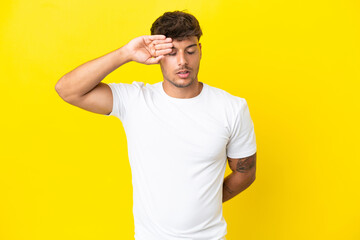 Fototapeta na wymiar Young caucasian handsome man isolated on yellow background with tired and sick expression