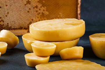 Blocks of beeswax for candle making. Raw beeswax. Handmade candle production - obrazy, fototapety, plakaty