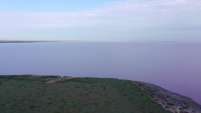 Evening time. Aerial view. Lake Lemuria - Pink Lake is a lake in the Kherson region of Ukraine. It has pink water due to the action of an algae which produces large amounts of beta-carotene.