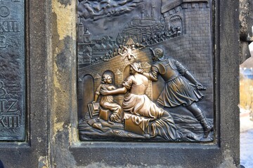 Touching the statue of Saint John of Nepomuk. It is supposed to bring good luck and to ensure that you return to Prague soon.
