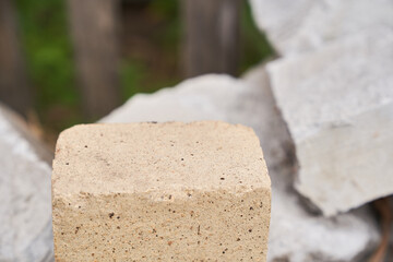 Stone podium. The pedestal is made of natural stone of beige color, on a stone background. High quality photo