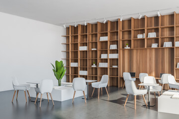 Office area with white and grey materials and shelving. Corner view.