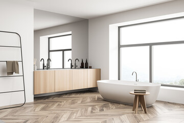 Fototapeta na wymiar Bathroom interior with white bathtub and large window