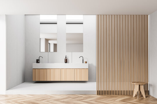 Bathroom with vanity, wooden stool and vertical mirrors