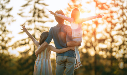 Happy family at sunset