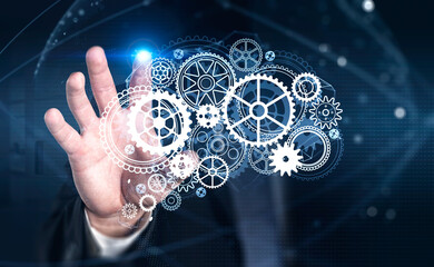 Businessman wearing formal suit is touching screen of digital interface