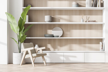 White wood niche shelf and armchair with indoor plant in seating area - obrazy, fototapety, plakaty