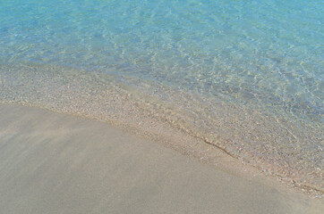 Fototapeta na wymiar A small wave of the sea covers the sand on the paradise beach.