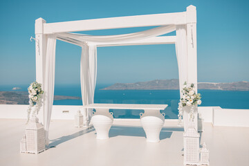 Wedding decorations with minimal white details on the background of the sea, Greece, Santorini. Luxury destination wedding. romantic couple travel vacation background