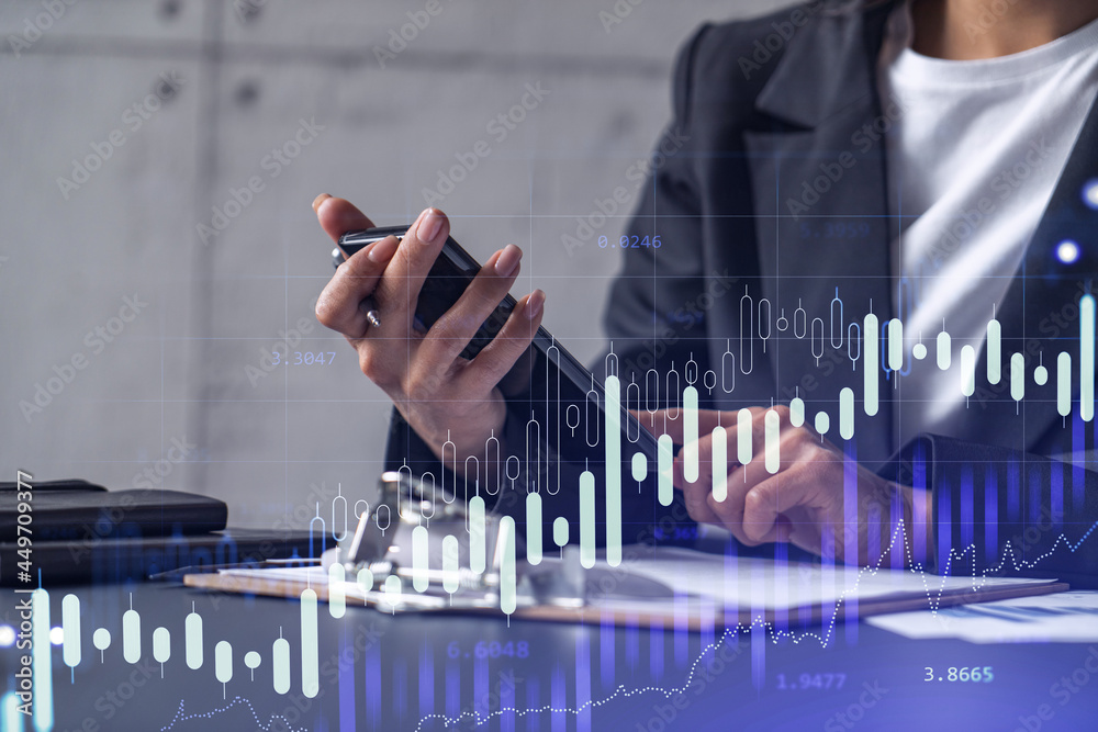 Wall mural A woman financial trader in formal wear is checking the phone to sign the contract to invest money in stock market. Internet trading and wealth management concept. Forex hologram chart.