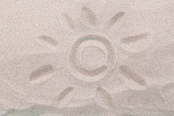 Drawing of the sun on the sand top view