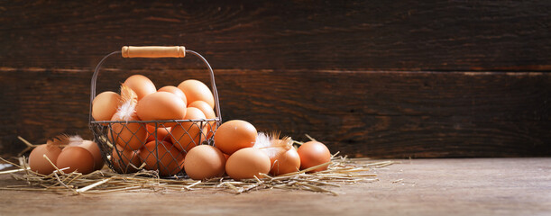 basket of chicken eggs on a wooden background