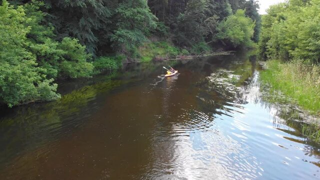 Aerial drone view of sport canoe on summer calm forest river