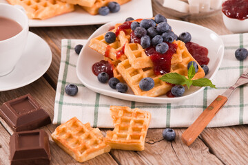 Waffles with blueberries and jam. 