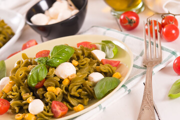 Fusilli pasta with cherry tomatoes and sweet corn.