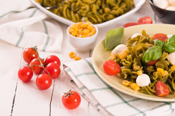 Fusilli pasta with cherry tomatoes and sweet corn.