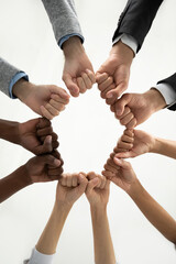 Close up crop vertical image of diverse multiethnic people join fists hands in circle show unity....