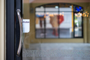 Restaurant door handle with push sign on glass doors
