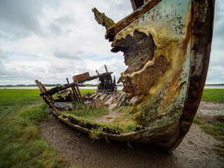 old boat on the beach fire damaged rusty wreck