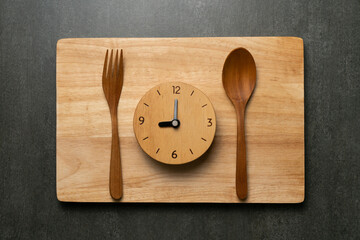 Food clock spoon and fork, Healthy food breakfast concept on black table background