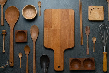 kitchen wooden utensils for cooking on the black table background, food prepare concept