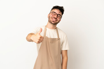 Restaurant waiter caucasian man isolated on white background with thumbs up because something good...