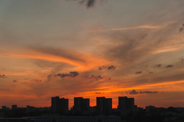 Fototapeta na wymiar Silhouettes of a metropolis at sunset in a modern city.