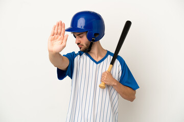 Young caucasian man playing baseball isolated on white background making stop gesture and disappointed