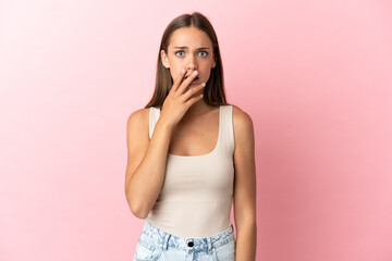 Young woman over isolated pink background surprised and shocked while looking right