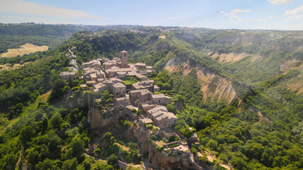 Panoramic aerial view of Civita di Bagnoregio from a flying drone around the medieval city, Italy.