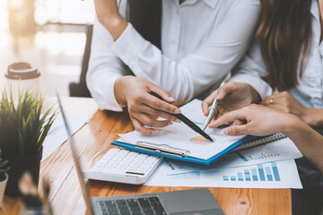 Close-up  businesswoman hand pointing at chart statistics meeting collaboration analysis at the office.