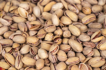 Roasted and salted pistachios in shell texture, background