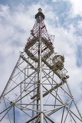 Communications tower with antennas against blue sky