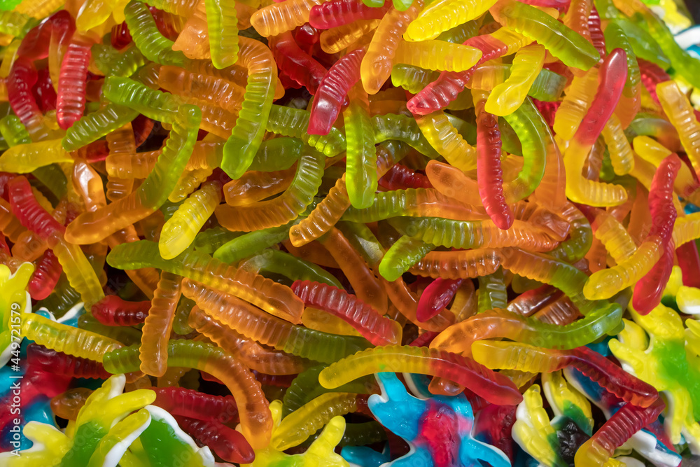 Sticker Colorful jelly candies in the form of worms. Candy background