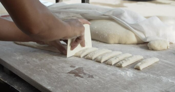 handheld 4K 25fps video of Chef is shaping dough sticks prepare to fry in hot oil.Youtiao is a hugely popular Chinese street food, a deep-fried breadstick crispy outside with a spongy interior.