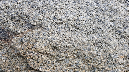 stone texture or background. Coarse cracked stone structure of the face. empty gray stone texture or background
