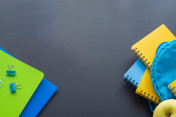 School supplies on a black school board. Back to school concept.