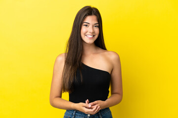 Obraz premium Young Brazilian woman isolated on yellow background laughing
