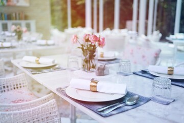 The wedding decor. Tables set for an event party or wedding reception. luxury elegant table setting dinner in a restaurant. glasses and dishes. hall for banquets and weddings.