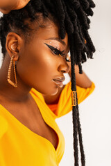 Fashion portrait of model beautiful African woman with clean healthy skin with with gold jewelry...