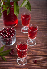 glasses of cherry brandy liqueur with ripe berries