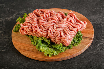 Raw pork minced meat over board