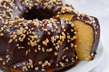 Homemade Gugelhupf, with a glaze of chocolate and chopped hazelnuts.