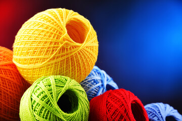 Assortment of different colored yarns and hook for crocheting